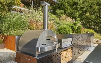 Outdoor-Küche aus Edelstahl mit Lochblech im Garten